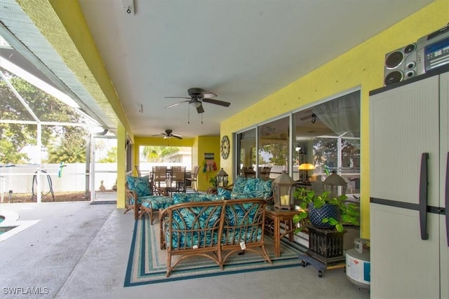 view of patio with glass enclosure and ceiling fan