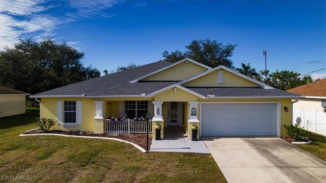 ranch-style house with a front lawn, covered porch, and a garage