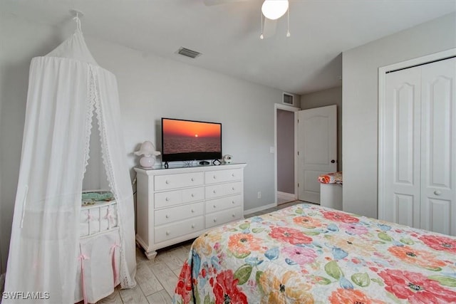 bedroom featuring ceiling fan, light wood-type flooring, and a closet