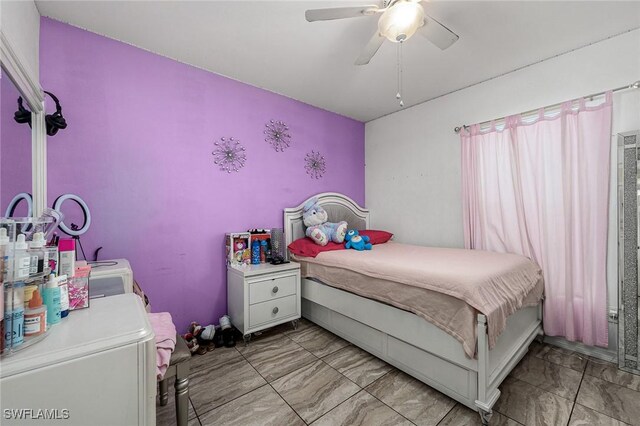 bedroom with washer and dryer and ceiling fan