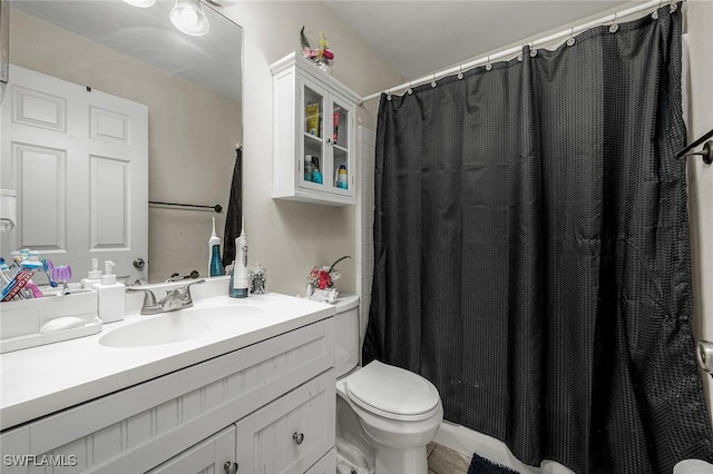 bathroom featuring vanity, a shower with shower curtain, and toilet