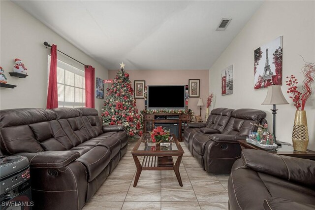 living area featuring visible vents and marble finish floor