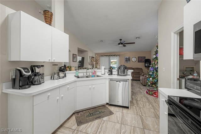 kitchen with a sink, open floor plan, a peninsula, light countertops, and dishwasher