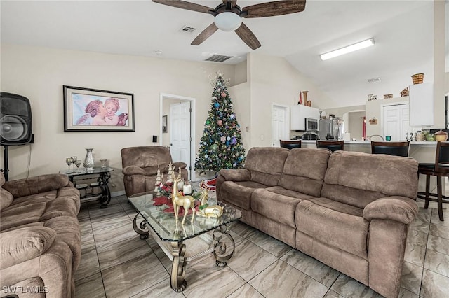 living room with ceiling fan and lofted ceiling