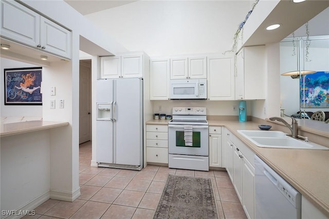 kitchen featuring white cabinetry, sink, light tile patterned flooring, and white appliances