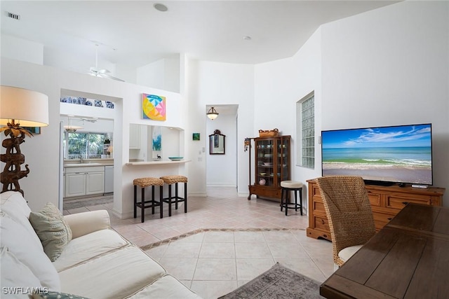 living room with light tile patterned floors and ceiling fan