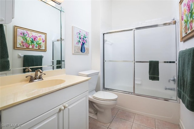 full bathroom with toilet, vanity, tile patterned floors, and enclosed tub / shower combo