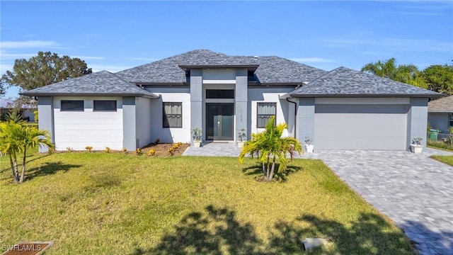 view of front of home featuring a garage and a front yard