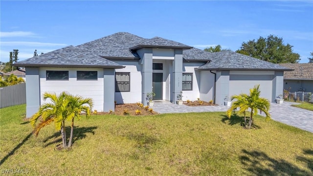 view of front of property featuring a front lawn and a garage