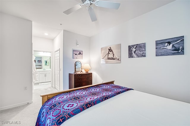 carpeted bedroom with connected bathroom and ceiling fan