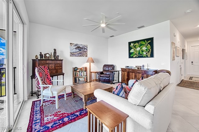 tiled living room featuring ceiling fan