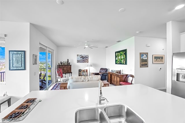 kitchen with ceiling fan, sink, and stainless steel refrigerator with ice dispenser