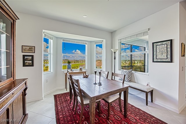 dining space featuring light tile patterned floors