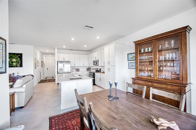 tiled dining area featuring sink