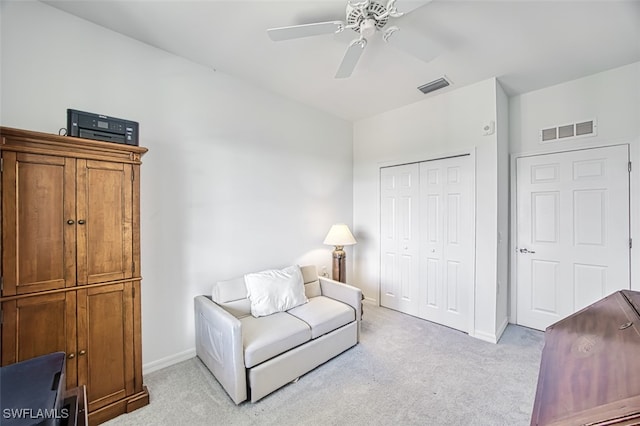 sitting room with light colored carpet and ceiling fan