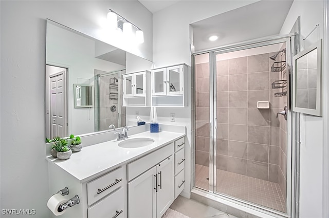 bathroom featuring vanity and an enclosed shower