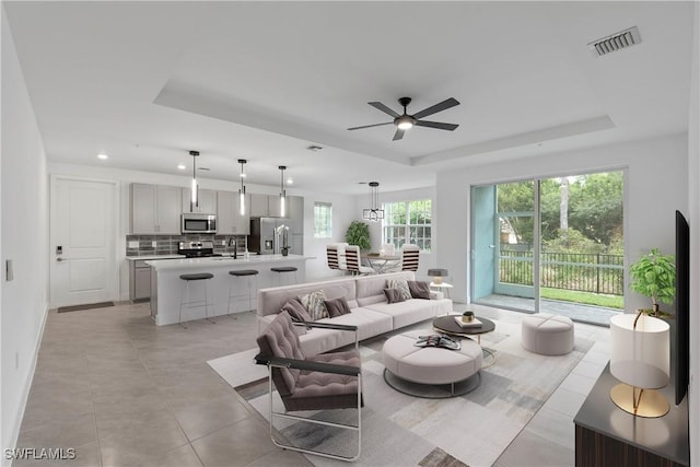 26390 Coco Cay Cir Unit 101, Bonita Springs, FL 34135 - living room featuring a raised ceiling, a ceiling fan, recessed lighting, light tile patterned floors, and visible vents