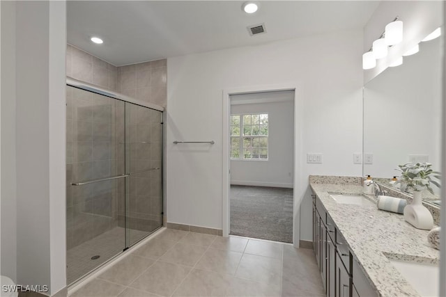 bathroom with vanity, tile patterned floors, and a shower with shower door