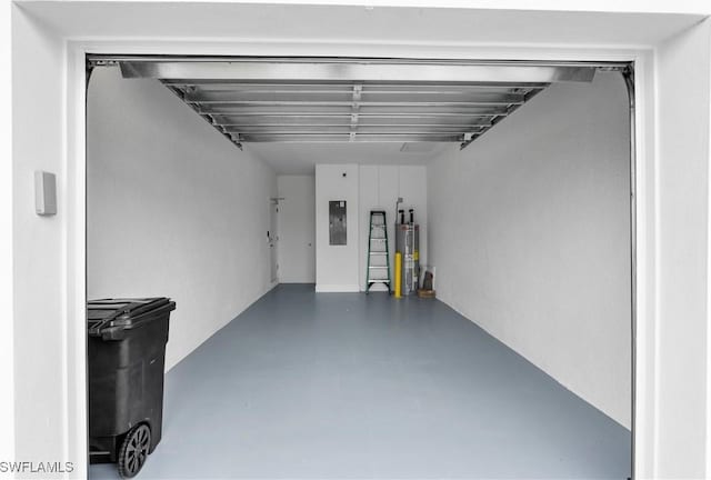 garage featuring electric panel and water heater