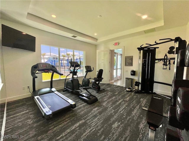 gym with a raised ceiling