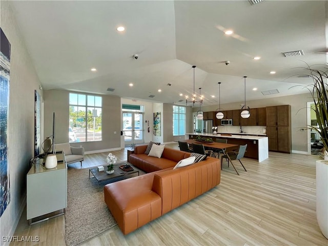 living room featuring lofted ceiling and light wood-type flooring