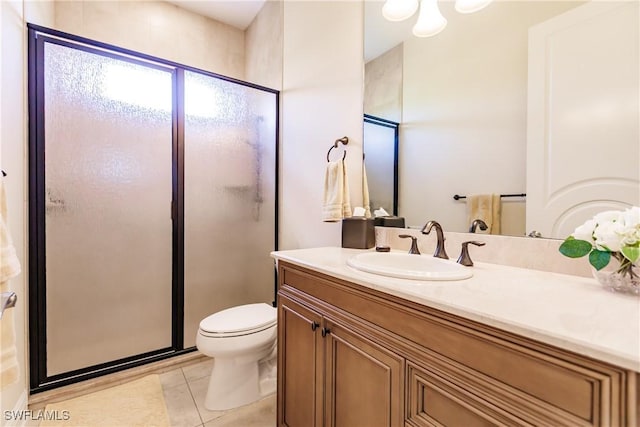 bathroom featuring tile patterned floors, toilet, vanity, and walk in shower