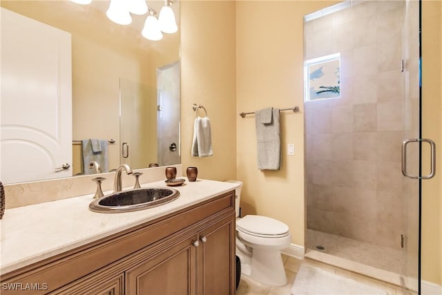 bathroom featuring tile patterned flooring, vanity, a shower with door, and toilet