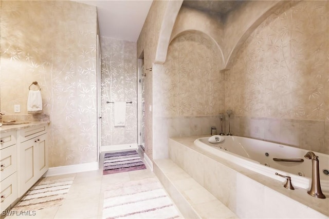 bathroom featuring tile patterned flooring, vanity, and separate shower and tub