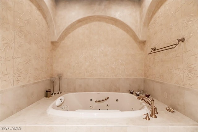 bathroom featuring tiled tub