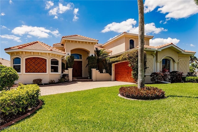 mediterranean / spanish-style home featuring a front yard