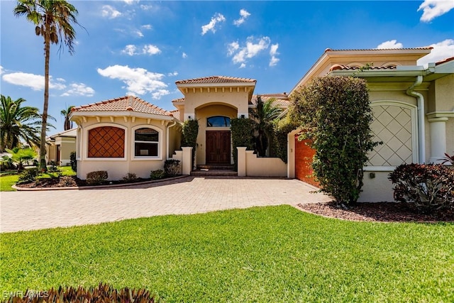 mediterranean / spanish-style house featuring a front lawn