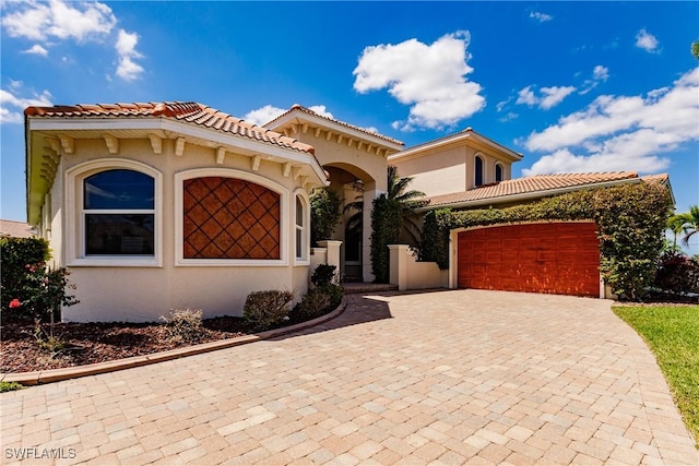 mediterranean / spanish-style house featuring a garage