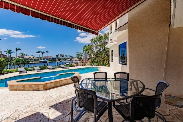 view of swimming pool with an in ground hot tub, a water view, and a patio