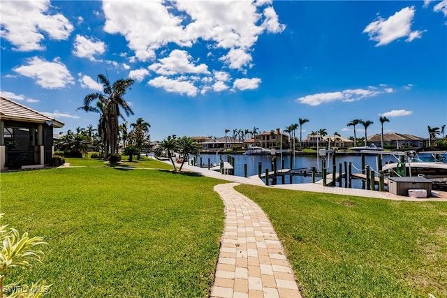 view of dock featuring a water view and a yard