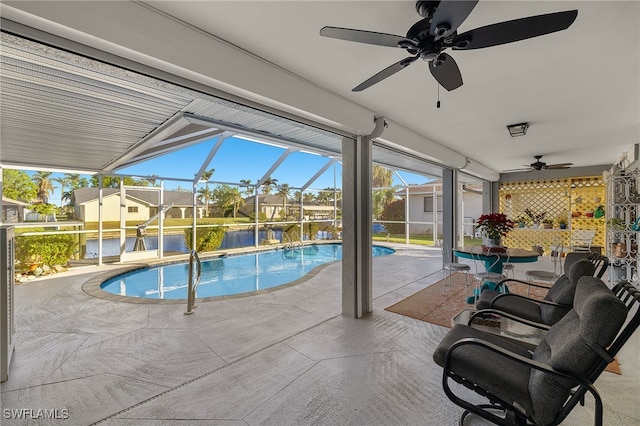 view of pool with ceiling fan and a water view