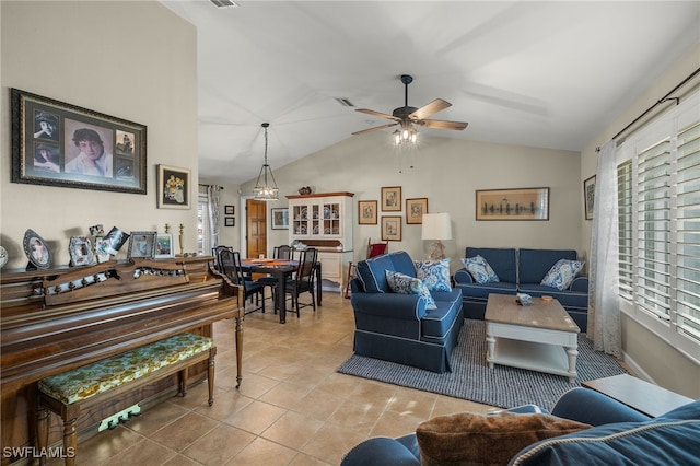 living room featuring ceiling fan, tile patterned floors, and vaulted ceiling