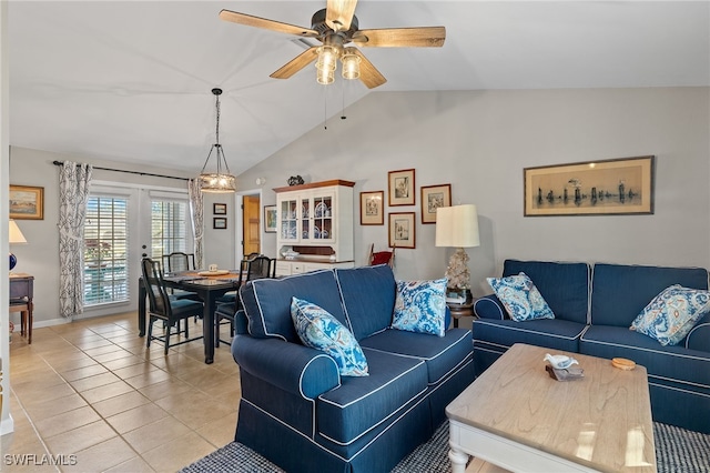 tiled living room with ceiling fan and vaulted ceiling