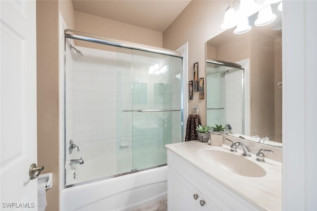 bathroom with tile patterned floors, vanity, and shower / bath combination with glass door