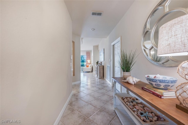 hall with light tile patterned flooring