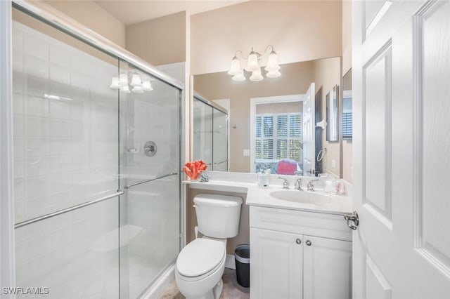 bathroom with walk in shower, vanity, and toilet