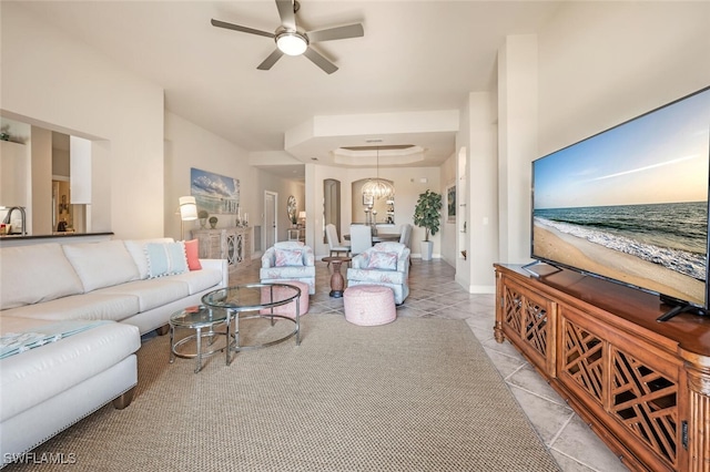 living room featuring light tile patterned floors, ceiling fan with notable chandelier, and sink