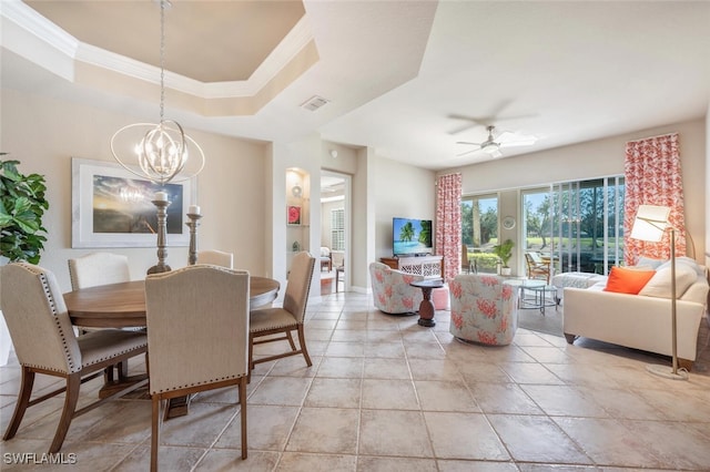 dining room featuring ceiling fan with notable chandelier, a tray ceiling, and ornamental molding