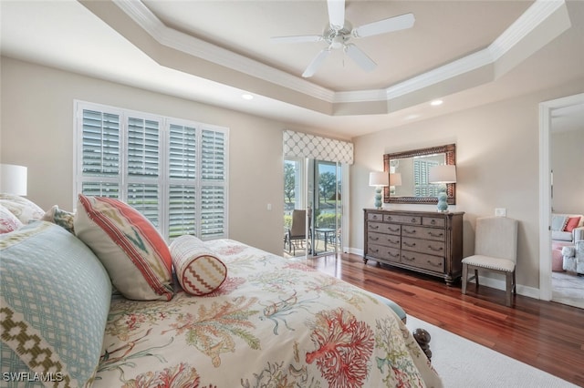 bedroom with ceiling fan, dark hardwood / wood-style floors, ornamental molding, and a raised ceiling