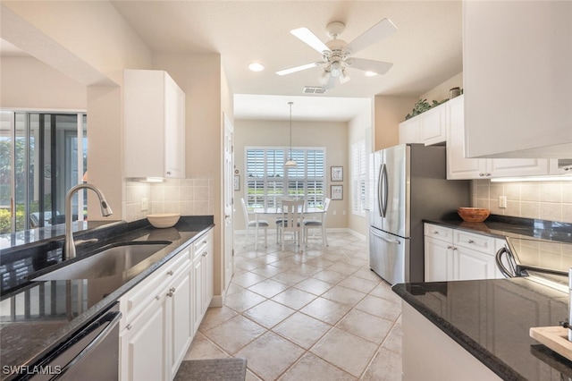 kitchen featuring pendant lighting, white cabinets, appliances with stainless steel finishes, sink, and ceiling fan