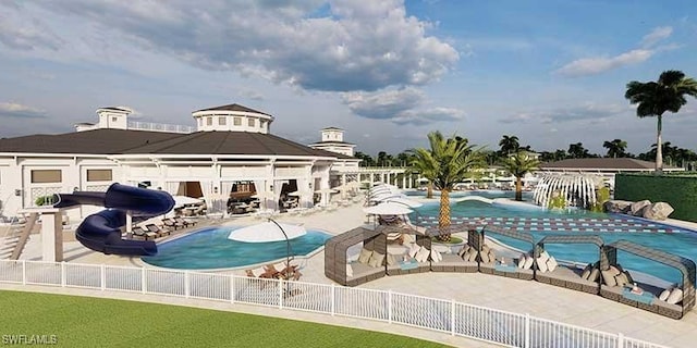 view of swimming pool with a water slide and a patio