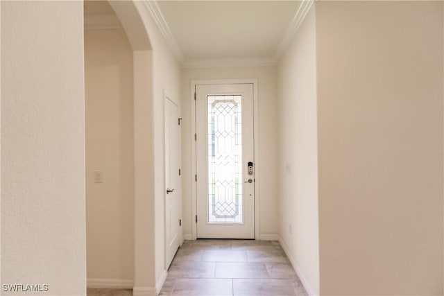 entryway with light tile patterned floors and crown molding