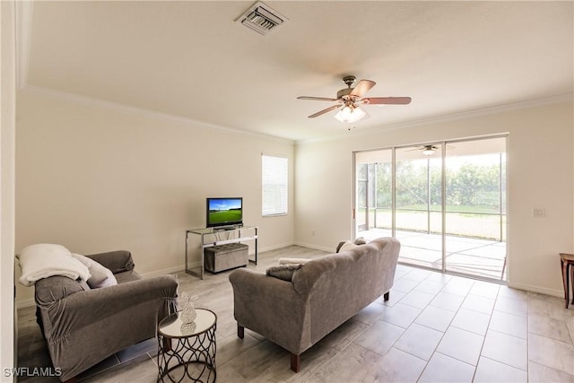 living room with ceiling fan, crown molding, and a wealth of natural light