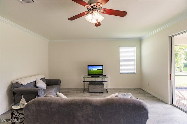 living room with a healthy amount of sunlight, ceiling fan, and ornamental molding