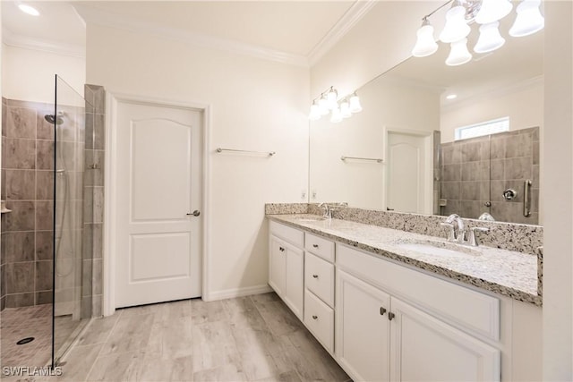 bathroom featuring a tile shower, vanity, crown molding, and hardwood / wood-style floors