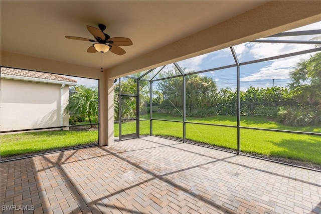 unfurnished sunroom with ceiling fan